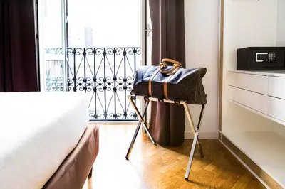a purse on a stand next to a bed in a room at LaHouse Rome by Premium Suites Collection in Rome