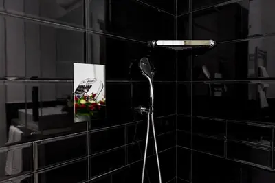 a black tiled bathroom with a blow dryer on a wall at LaHouse Rome by Premium Suites Collection in Rome