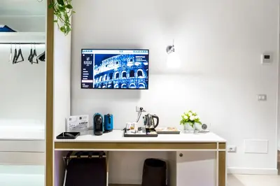 a desk in a room with a picture on the wall at LaHouse Rome by Premium Suites Collection in Rome