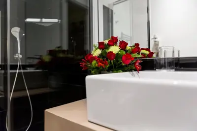 a bouquet of red and yellow flowers sitting on a counter at LaHouse Rome by Premium Suites Collection in Rome