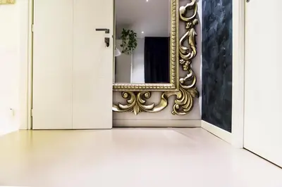 a hallway with a mirror and white walls at LaHouse Rome by Premium Suites Collection in Rome