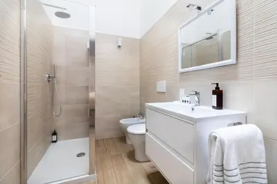 a bathroom with a toilet and a sink and a shower at Charme & Chic Nazionale in Rome