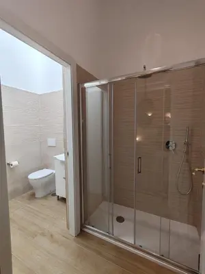 a bathroom with a glass shower with a toilet at Charme & Chic Nazionale in Rome
