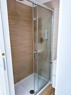 a shower with a glass door in a bathroom at Charme & Chic Nazionale in Rome