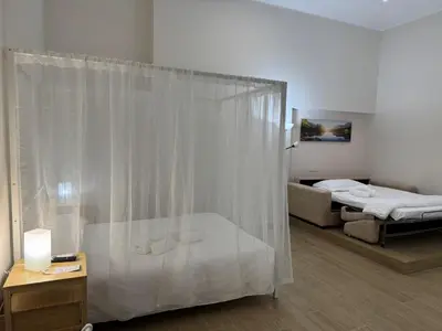 a bathroom with a shower and a bed in a room at Charme & Chic Nazionale in Rome