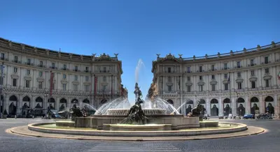 a fountain in front of a large building at Charme & Chic Nazionale in Rome