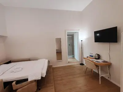a bedroom with a bed and a desk and a television at Charme & Chic Nazionale in Rome