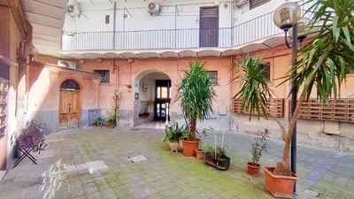 a courtyard with potted plants in a building at Sanniti Loft San Lorenzo in Rome