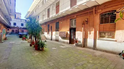 an empty alley with plants in front of a building at Sanniti Loft San Lorenzo in Rome