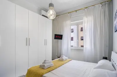 a bedroom with a bed with towels on it at ArtStay AC Apt Near Metro, Fiumicino Airport in Rome