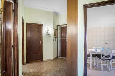 a hallway with a room with a table and a door at ArtStay AC Apt Near Metro, Fiumicino Airport in Rome