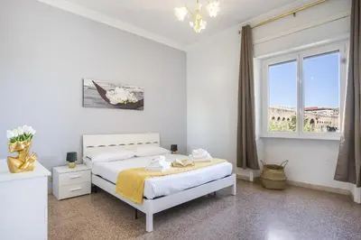 a white bedroom with a bed and a window at ArtStay AC Apt Near Metro, Fiumicino Airport in Rome
