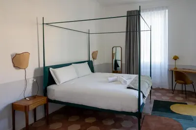 a bedroom with a bed with a four post canopy at Dimora Malatesta @ The Vatican in Rome