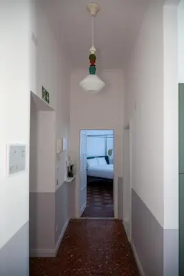 a hallway with a room with a bed and a light at Dimora Malatesta @ The Vatican in Rome