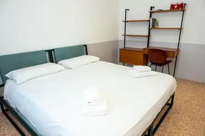 a bedroom with a bed and a desk and a chair at Dimora Malatesta @ The Vatican in Rome