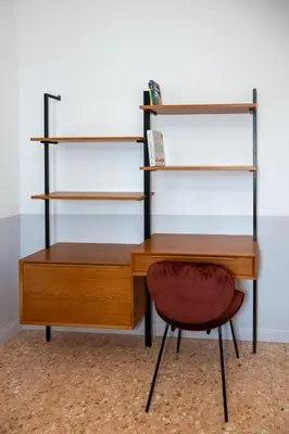 a wooden desk with a chair and shelves at Dimora Malatesta @ The Vatican in Rome