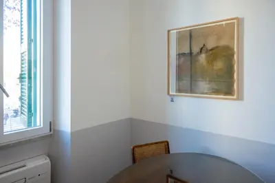 a dining room with a table and a painting on the wall at Dimora Malatesta @ The Vatican in Rome