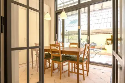 a dining room with a wooden table and chairs at Quattro Cantoni Apartment Monti in Rome