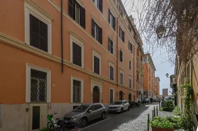 two cars parked on a street next to a building at Quattro Cantoni Apartment Monti in Rome