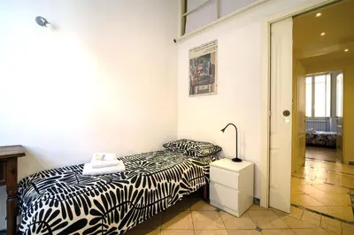a bedroom with a bed and a lamp on a night stand at Quattro Cantoni Apartment Monti in Rome