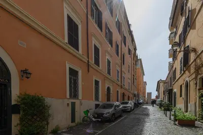an alley with cars parked on the side of a building at Quattro Cantoni Apartment Monti in Rome