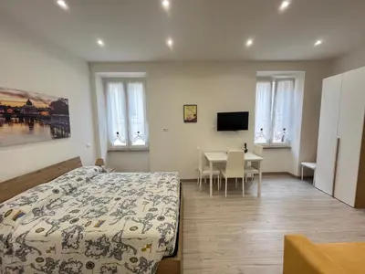 a bedroom with a bed and a table and a television at SpecchiamoR in Rome