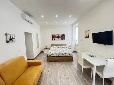 a bedroom with a bed and a couch and a table at SpecchiamoR in Rome