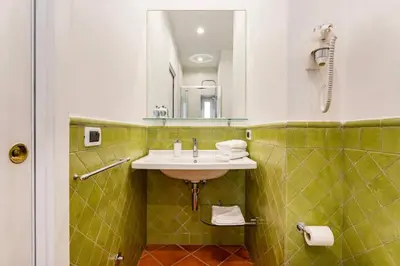 a bathroom with a sink and a mirror at Fori Imperiali Luxe Mansion in Rome