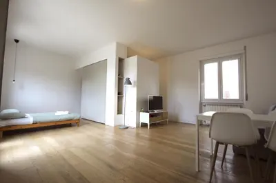 a large white room with a desk and a bed at Statonia Terrace Penthouse in Rome