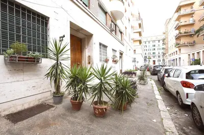 a group of potted plants on a sidewalk next to a building at Statonia Terrace Penthouse in Rome