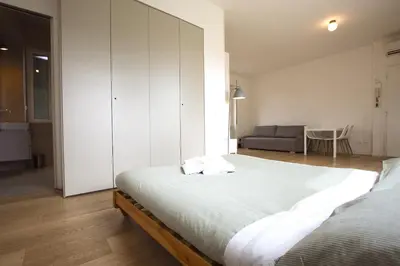a bedroom with a large bed and a couch at Statonia Terrace Penthouse in Rome