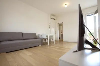 a living room with a couch and a tv at Statonia Terrace Penthouse in Rome