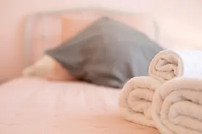 a pile of towels sitting on top of a bed at Alchimia Friends and Family 3 bedrooms 3 bathrooms in Rome