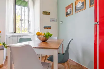 a dining room table with a bowl of fruit on it at Alchimia Friends and Family 3 bedrooms 3 bathrooms in Rome