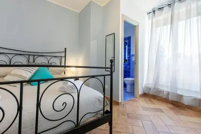 a bedroom with a bed and a bathroom at Alchimia Friends and Family 3 bedrooms 3 bathrooms in Rome