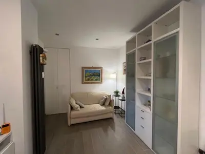 a living room with a couch and a room with shelves at Casa Dalia in Rome