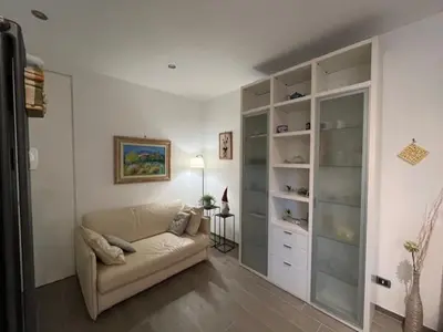 a living room with a couch and some shelves at Casa Dalia in Rome