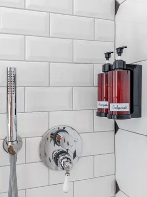 a bathroom with a blow dryer on a wall at Maison Bonheur in Rome