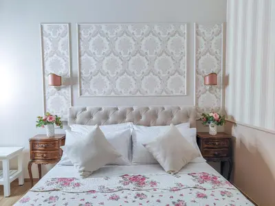 a bedroom with a large bed and two night stands at Maison Bonheur in Rome