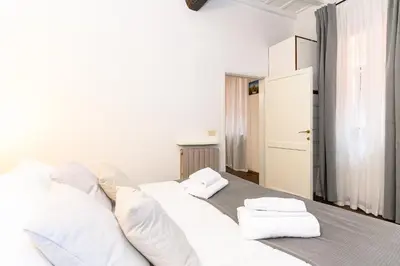 a white bed with two towels on top of it at Central near Piazza Navona by NDP rent in Rome