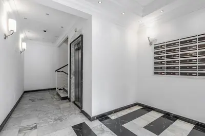 a hallway with a door and a wall with wine bottles at Portuense 107 - Bright Flat in Rome