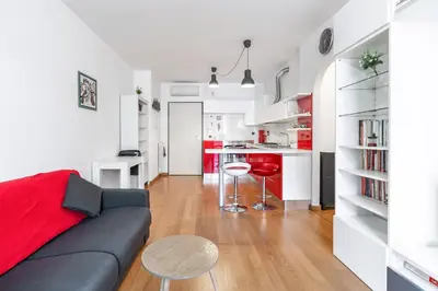a living room and kitchen with a couch and a table at Portuense 107 - Bright Flat in Rome