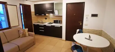 a kitchen with a couch and a table in a room at Cosy penthouse loft with view in Rome