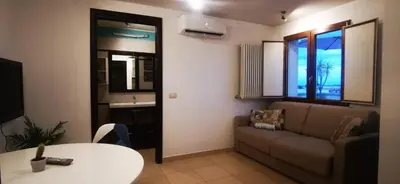 a living room with a couch and a table at Cosy penthouse loft with view in Rome