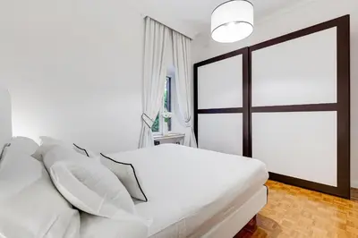 a bedroom with a white bed and a window at New Sistina Suite - Your Italian Holidays in Rome