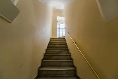 a stairway leading up to a door in a building at New Sistina Suite - Your Italian Holidays in Rome