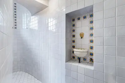 a white tiled bathroom with a sink in it at New Sistina Suite - Your Italian Holidays in Rome