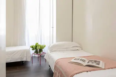 a bedroom with a bed with a book on it at Luxury Blu Rome in Rome