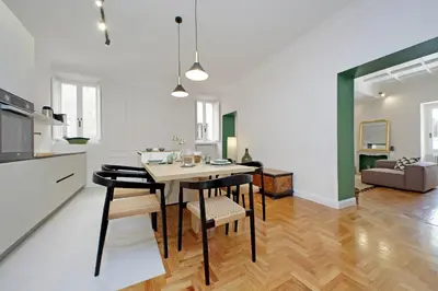 a kitchen and dining room with a table and chairs at YCH-Casa Bella- Luxury home near Piazza Venezia in Rome