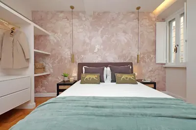 a bedroom with a bed and a pink wall at YCH-Casa Bella- Luxury home near Piazza Venezia in Rome